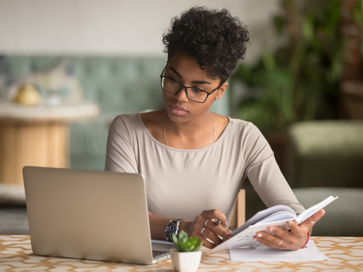 woman w/ glasses working